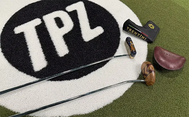 Trentini putters laid out over TPZ logo carpet